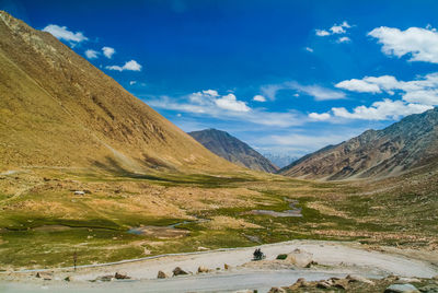 Scenic view of mountains against blue sky