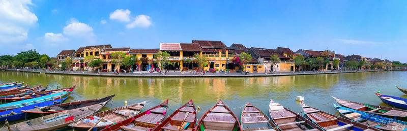 Panoramic view of buildings by canal against sky