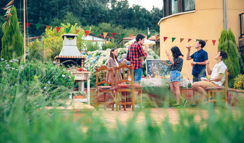 Friends having leisure time together at backyard