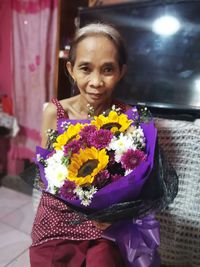 Portrait of a smiling girl holding flower