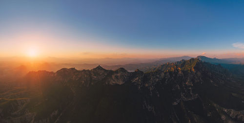 Scenic view of mountains against sky during sunset