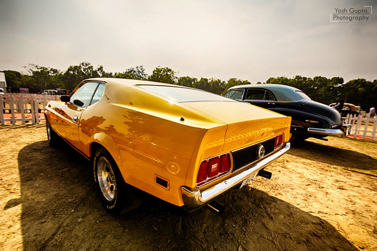 car, land vehicle, transportation, mode of transport, stationary, outdoors, no people, yellow, day, sky