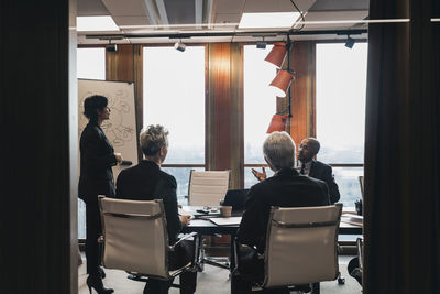 Business colleagues planning strategy during meeting in board room at office
