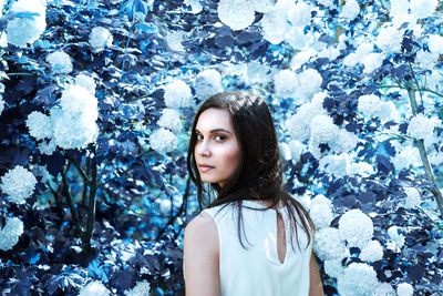 Portrait of young woman in flowers