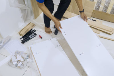 Low section of person standing on paper