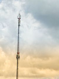 Low angle view of communications tower against sky