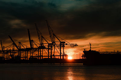 Large ship to shore container cranes at sunset
