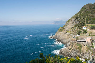 High angle view of cliff and sea against sky
