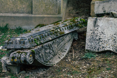 Old abandoned car on stone wall