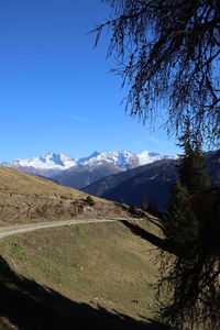 Scenic view of snowcapped mountains against clear blue sky