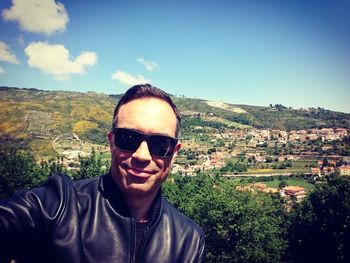 Portrait of man wearing sunglasses against sky