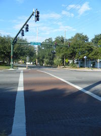 Empty road along trees