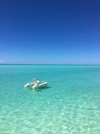 Boat moored on sea against sky