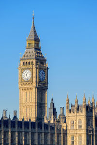 Clock tower in city against clear sky