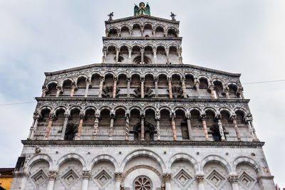Facade of the church san michele in foro in lucca, finely decorated with statues and sculptures