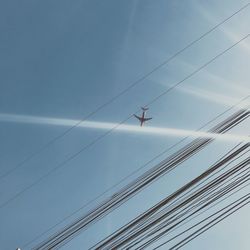 Low angle view of cables against blue sky