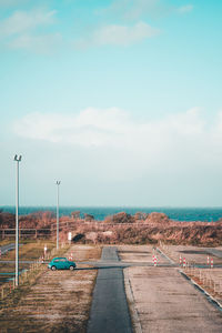 Road by sea against sky