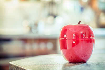 Close-up of apple container with measures on table