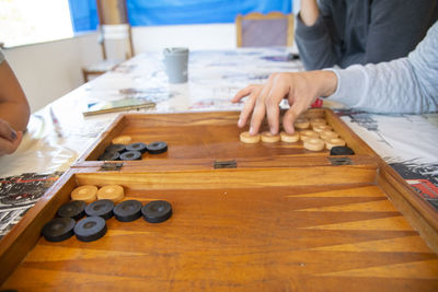 Midsection of man playing leisure game 