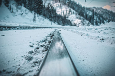 Railroad rails close up on the background of snowy mountains