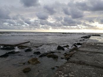 Scenic view of sea against storm clouds