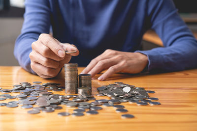 Midsection of man playing jigsaw puzzle on table