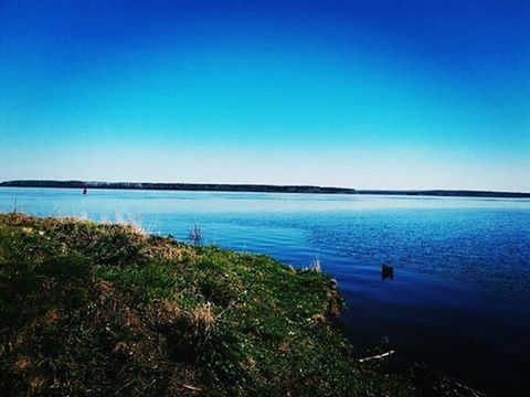 water, blue, clear sky, copy space, tranquil scene, sea, tranquility, scenics, beauty in nature, nature, horizon over water, idyllic, lake, nautical vessel, calm, shore, outdoors, plant, day, beach