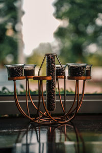 Close-up of metallic structure on table against lake