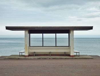 Scenic view of calm sea against cloudy sky