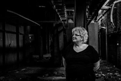 Portrait of man standing in abandoned building