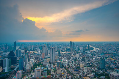 High angle view of modern buildings against sky during sunset