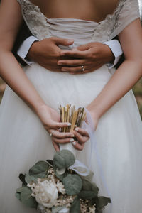 Midsection of woman holding hands