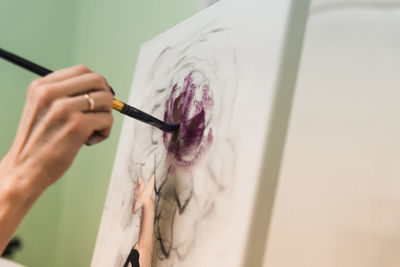 Close-up of person hand holding painting