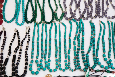 High angle view of necklaces arranged on table for sale in store