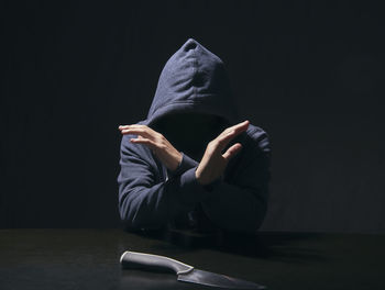 Midsection of a person sitting in the dark