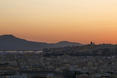 High angle view of townscape against orange sky