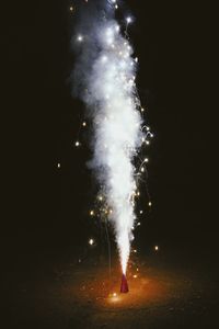 Low angle view of firework display at night