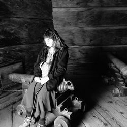 Close-up of woman standing on bench