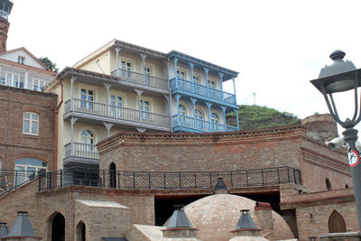 Low angle view of old building in town against sky