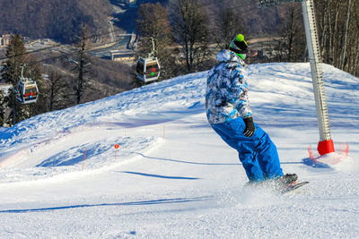 Man skiing on snow covered field