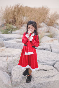 Portrait of young woman standing outdoors