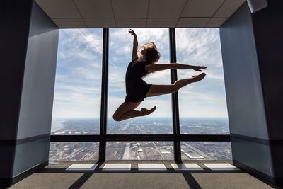 Full length of woman jumping in mid-air