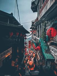 Group of people in market against buildings in city