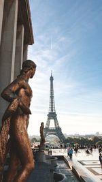 View of statue in city against sky