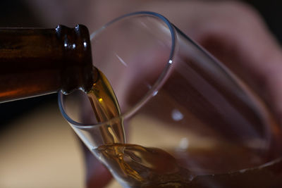 Close-up of wine being poured in glass