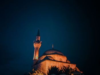 Low angle view of illuminated building against sky at night