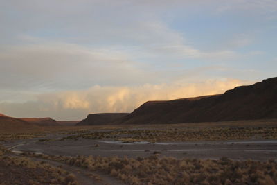 Scenic view of desert against sky during sunset