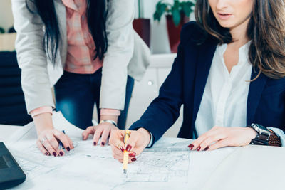 Low section of women working on table