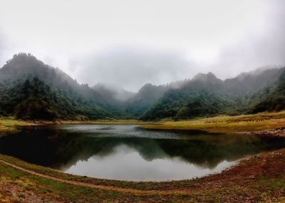 Scenic view of lake and mountains against sky