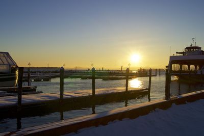 Pier on sea at sunset